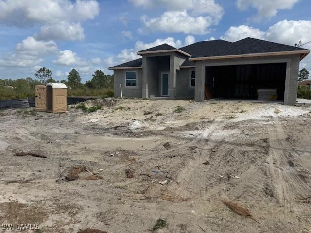 2918 29th St W, Lehigh Acres, FL 33971 - view of front of home with a garage