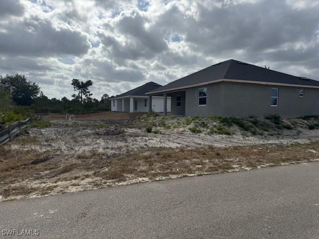 2918 29th St W, Lehigh Acres, FL 33971 - view of side of property with stucco siding
