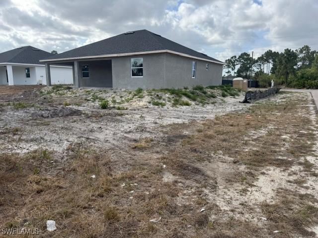 2918 29th St W, Lehigh Acres, FL 33971 - view of home's exterior featuring stucco siding