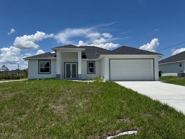 2918 29th St W, Lehigh Acres, FL 33971 - prairie-style house featuring french doors, a garage, driveway, and stucco siding