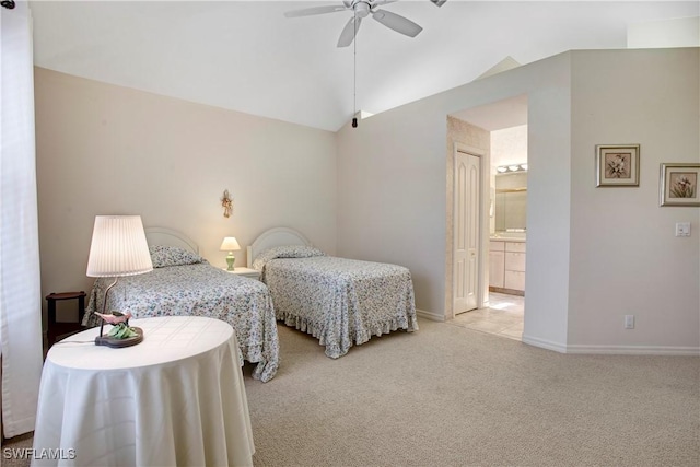 bedroom with baseboards, a ceiling fan, carpet floors, ensuite bath, and vaulted ceiling