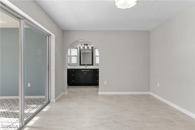 interior space featuring vanity and baseboards