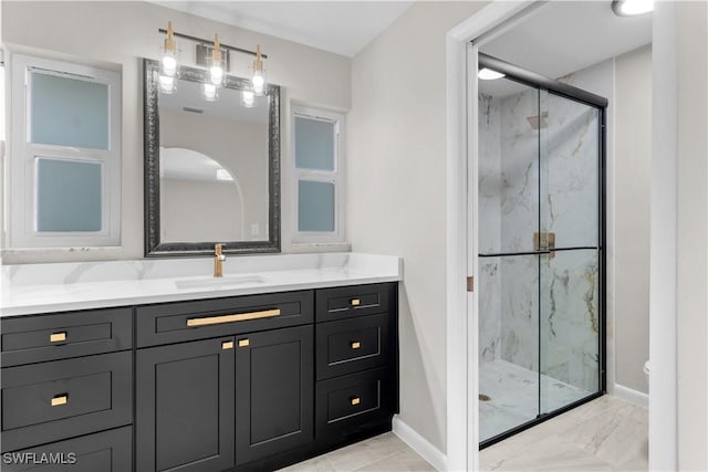 bathroom with baseboards, a marble finish shower, marble finish floor, and vanity