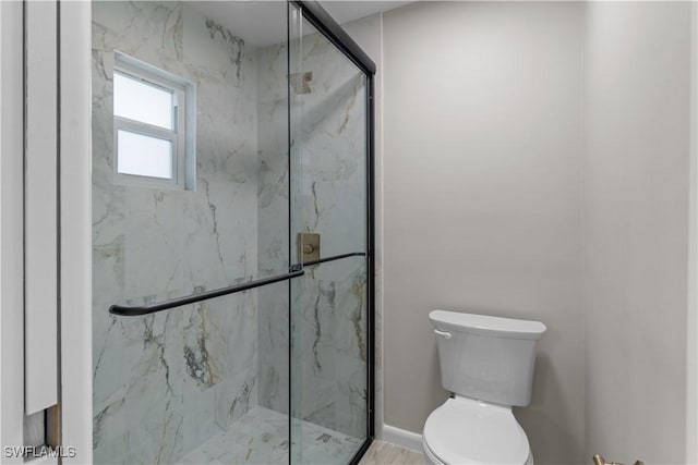 full bathroom featuring a marble finish shower and toilet