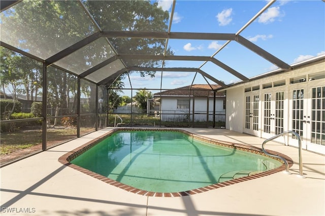 pool featuring a patio area, a lanai, and french doors