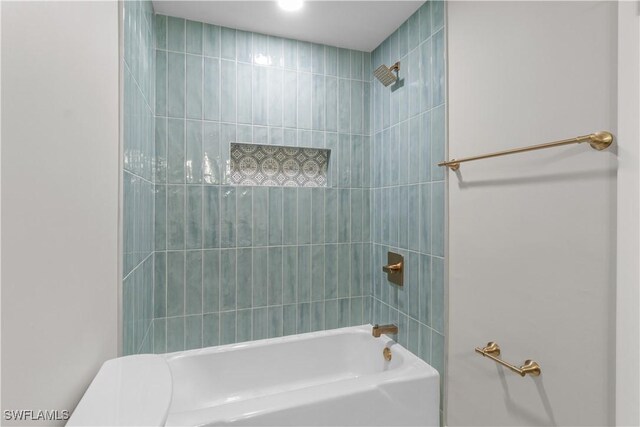 bathroom featuring shower / bath combination and toilet