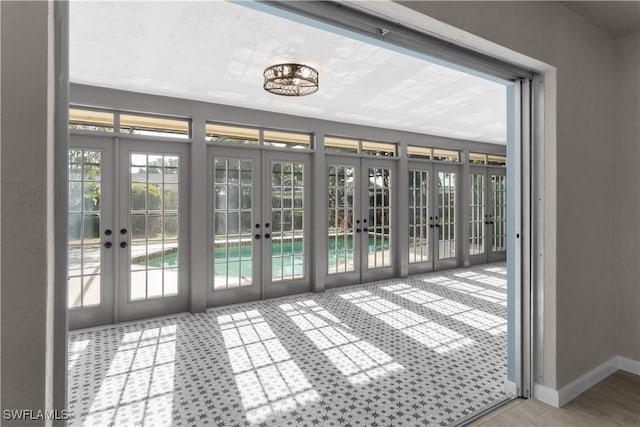 entryway with baseboards and french doors