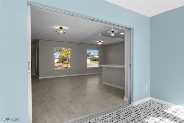 interior space featuring baseboards and tile patterned floors