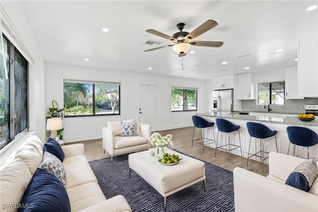 3433 Hibiscus Ave, Naples, FL 34104 - living area featuring light wood-style floors, visible vents, baseboards, and ceiling fan