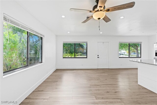 3433 Hibiscus Ave, Naples, FL 34104 - unfurnished living room featuring light wood-style flooring, ceiling fan, baseboards, and recessed lighting