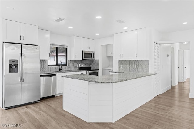 3433 Hibiscus Ave, Naples, FL 34104 - kitchen featuring light wood-type flooring, visible vents, appliances with stainless steel finishes, light stone counters, and a sink
