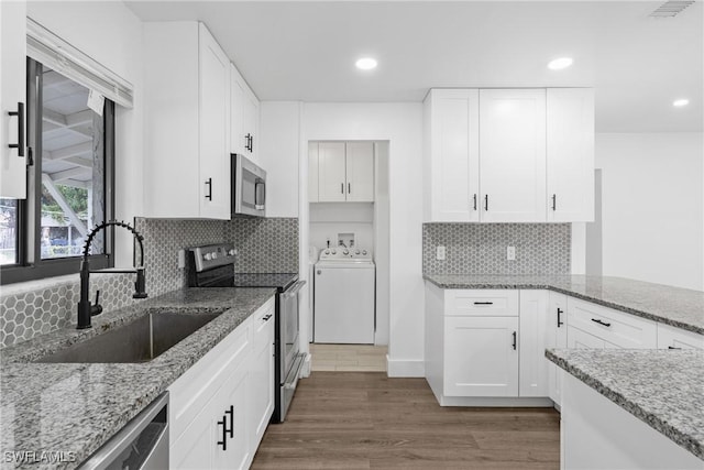 3433 Hibiscus Ave, Naples, FL 34104 - kitchen with wood finished floors, light stone countertops, a sink, and appliances with stainless steel finishes