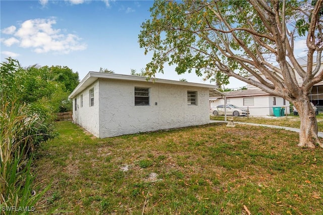 3433 Hibiscus Ave, Naples, FL 34104 - rear view of property featuring a yard, fence, and stucco siding