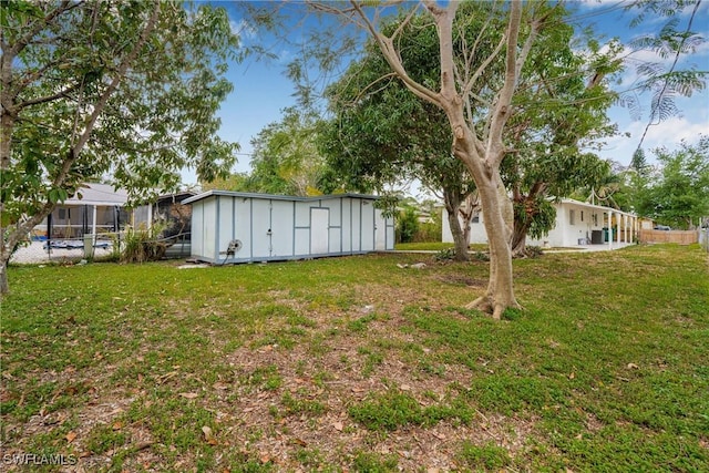 3433 Hibiscus Ave, Naples, FL 34104 - view of yard featuring an outdoor structure and fence