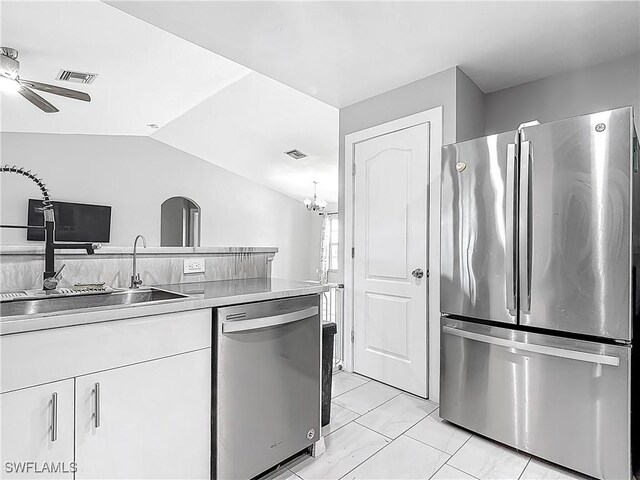 2732 NW 3rd Ter, Cape Coral, FL 33993 - kitchen featuring visible vents, white cabinets, appliances with stainless steel finishes, ceiling fan with notable chandelier, and lofted ceiling