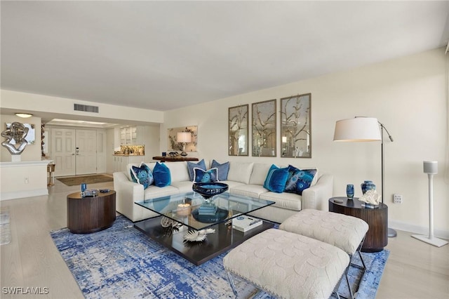 4031 Gulf Shore Blvd N Unit 3E, Naples, FL 34103 - living room featuring visible vents, baseboards, and wood finished floors