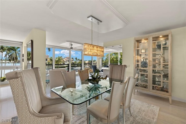 4031 Gulf Shore Blvd N Unit 3E, Naples, FL 34103 - dining room with a tray ceiling, wood finished floors, and ceiling fan