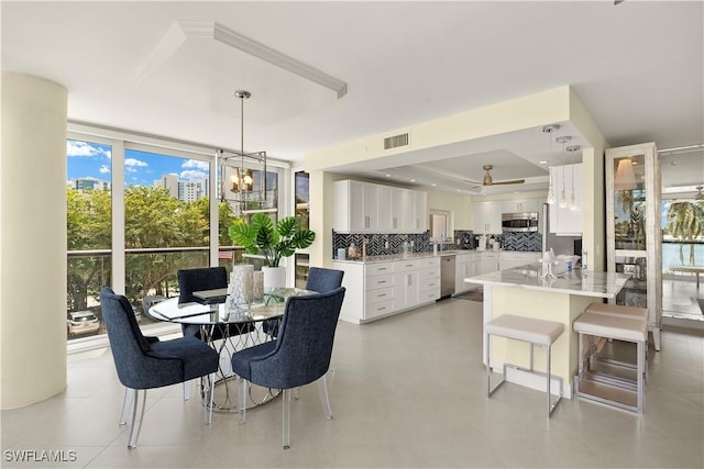4031 Gulf Shore Blvd N Unit 3E, Naples, FL 34103 - dining area featuring a raised ceiling, ceiling fan with notable chandelier, and visible vents