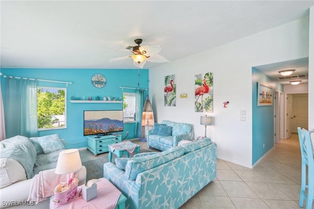 living area featuring visible vents, tile patterned floors, and a ceiling fan