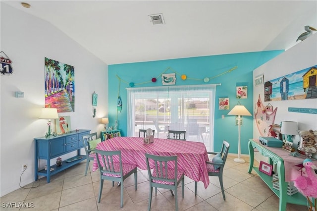 dining room featuring tile patterned flooring, visible vents, and vaulted ceiling
