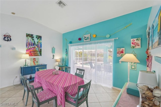 dining space featuring visible vents, baseboards, light tile patterned flooring, and lofted ceiling