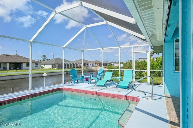pool with a water view, a patio, and a lanai