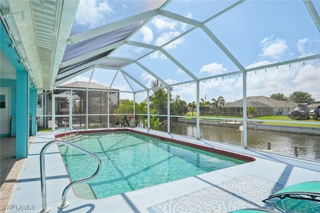 outdoor pool featuring a water view, a patio area, and a lanai