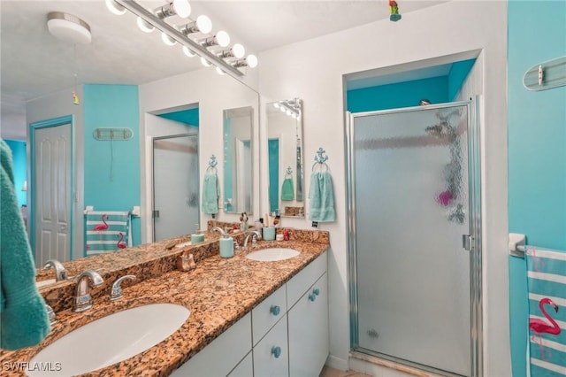 full bath with a stall shower and a sink