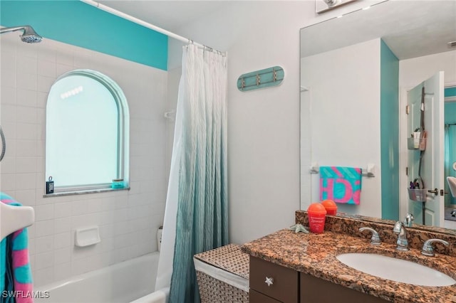 bathroom featuring shower / bathtub combination with curtain and vanity