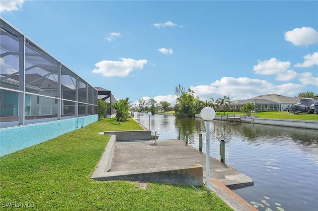 dock area with a lanai, a residential view, a water view, and a lawn