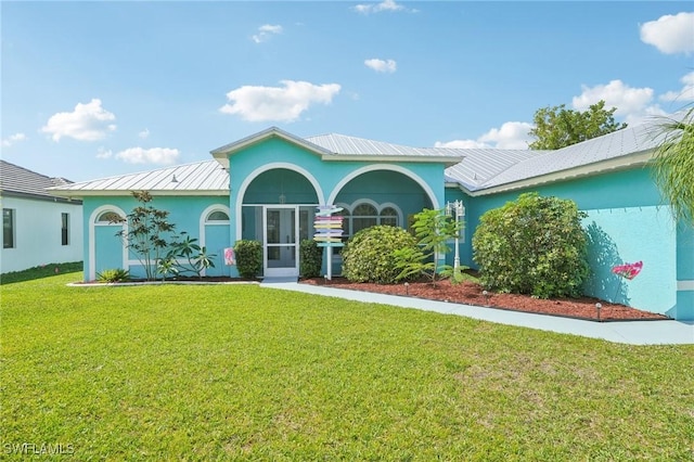 view of front of home with stucco siding and a front lawn
