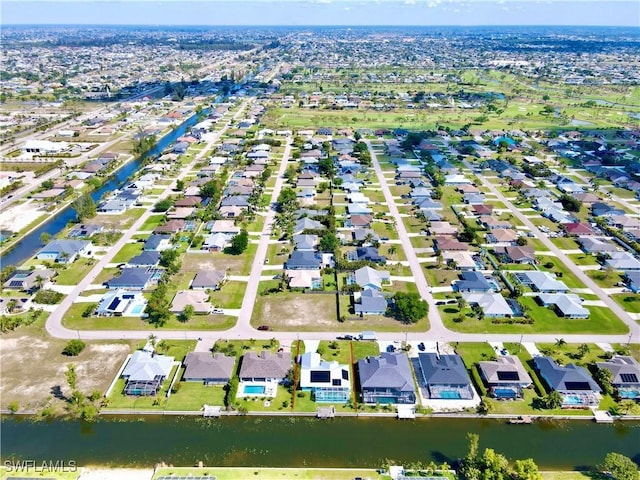 bird's eye view with a residential view and a water view