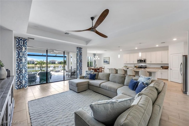 11477 Canopy Loop, Fort Myers, FL 33913 - living room with ceiling fan, recessed lighting, a water view, and a tray ceiling