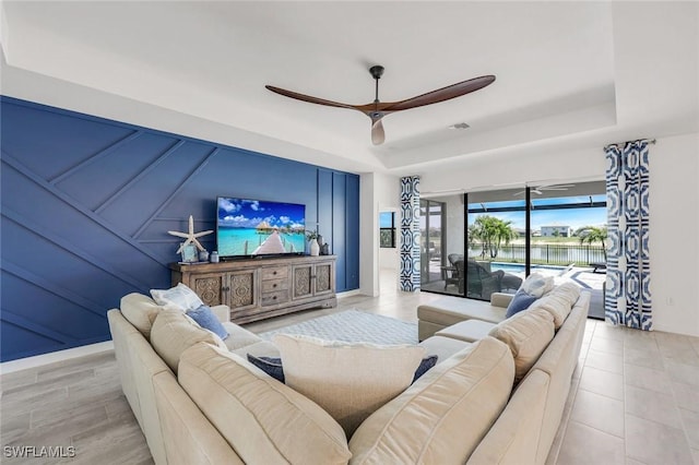 11477 Canopy Loop, Fort Myers, FL 33913 - living room featuring a tray ceiling and a ceiling fan