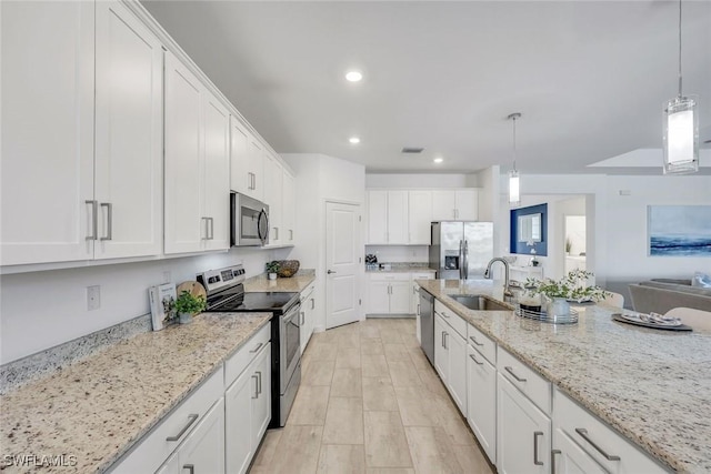 11477 Canopy Loop, Fort Myers, FL 33913 - kitchen with stainless steel appliances, a sink, white cabinets, recessed lighting, and pendant lighting