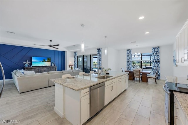 11477 Canopy Loop, Fort Myers, FL 33913 - kitchen with appliances with stainless steel finishes, a sink, white cabinets, an island with sink, and decorative light fixtures