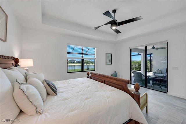 11477 Canopy Loop, Fort Myers, FL 33913 - bedroom with a tray ceiling, access to exterior, ceiling fan, and baseboards