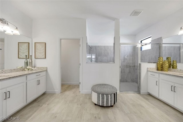 11477 Canopy Loop, Fort Myers, FL 33913 - bathroom with a stall shower, two vanities, and baseboards
