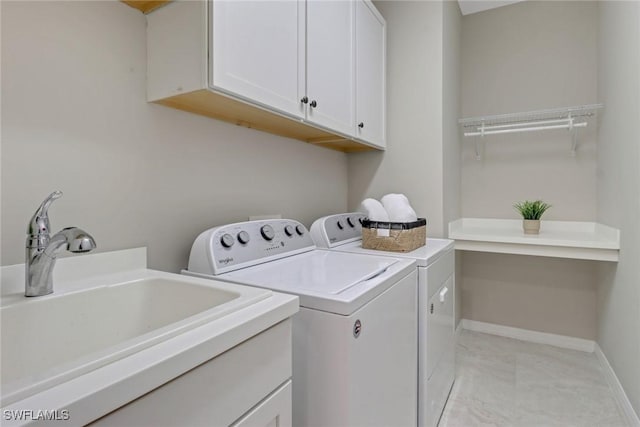 7175 Wilton Dr, Naples, FL 34109 - clothes washing area featuring independent washer and dryer, marble finish floor, a sink, baseboards, and cabinet space