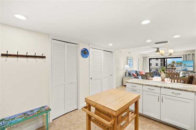 671 E Gulf Dr Unit 2C2, Sanibel, FL 33957 - kitchen with white cabinets, recessed lighting, light stone countertops, and visible vents