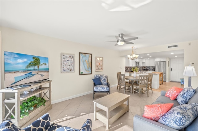 671 E Gulf Dr Unit 2C2, Sanibel, FL 33957 - living area featuring ceiling fan with notable chandelier, light tile patterned floors, baseboards, and visible vents
