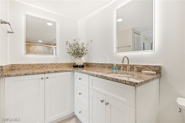 671 E Gulf Dr Unit 2C2, Sanibel, FL 33957 - bathroom with a shower with door, double vanity, recessed lighting, toilet, and a sink