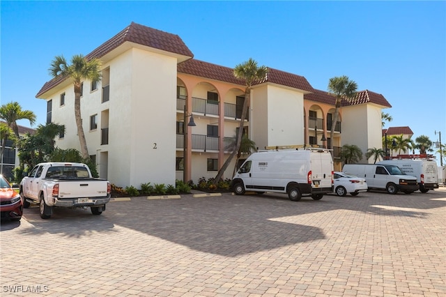 671 E Gulf Dr Unit 2C2, Sanibel, FL 33957 - view of building exterior with uncovered parking