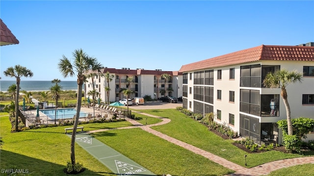671 E Gulf Dr Unit 2C2, Sanibel, FL 33957 - view of home's community featuring shuffleboard, a swimming pool, a water view, and a lawn