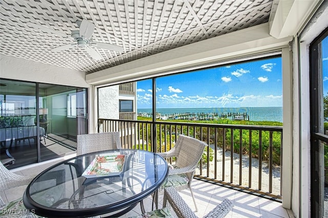 15123 Captiva Dr Unit 104, Captiva, FL 33924 - sunroom / solarium with ceiling fan, outdoor dining area, and a water view