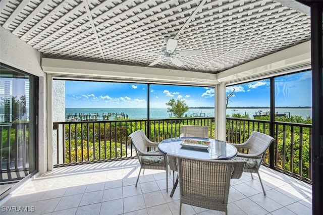 15123 Captiva Dr Unit 104, Captiva, FL 33924 - sunroom featuring outdoor dining area, ceiling fan, tile patterned flooring, and a water view