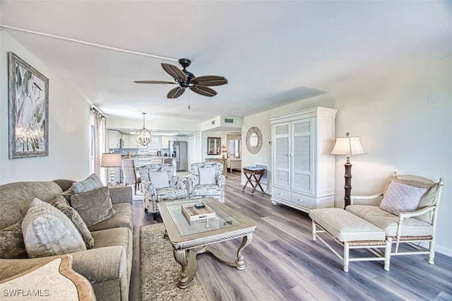 15123 Captiva Dr Unit 104, Captiva, FL 33924 - living area featuring visible vents, a ceiling fan, and wood finished floors