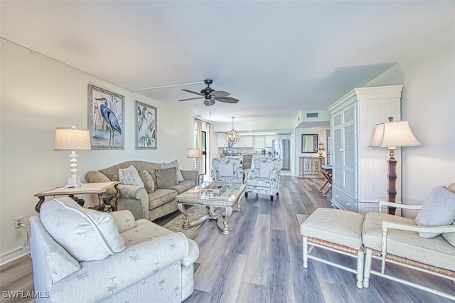 15123 Captiva Dr Unit 104, Captiva, FL 33924 - living area featuring visible vents, baseboards, a ceiling fan, and wood finished floors