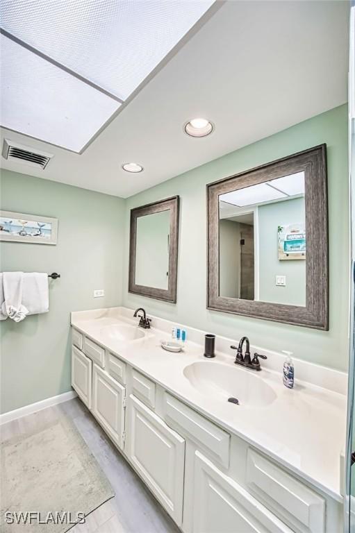 15123 Captiva Dr Unit 104, Captiva, FL 33924 - full bathroom with a sink, visible vents, baseboards, and double vanity