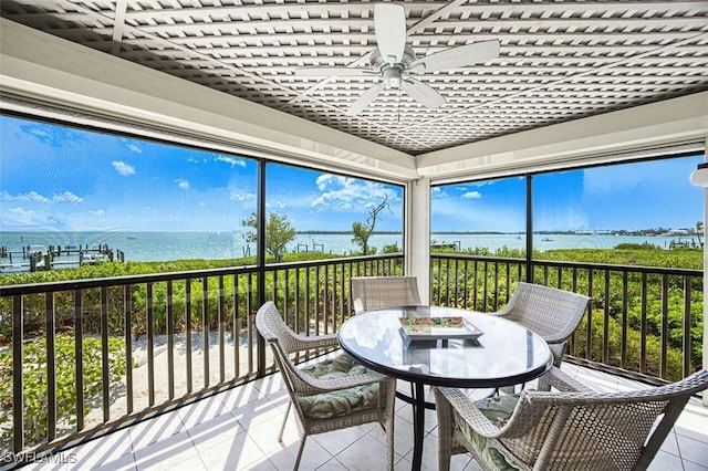 15123 Captiva Dr Unit 104, Captiva, FL 33924 - sunroom with outdoor dining space, a ceiling fan, and a water view